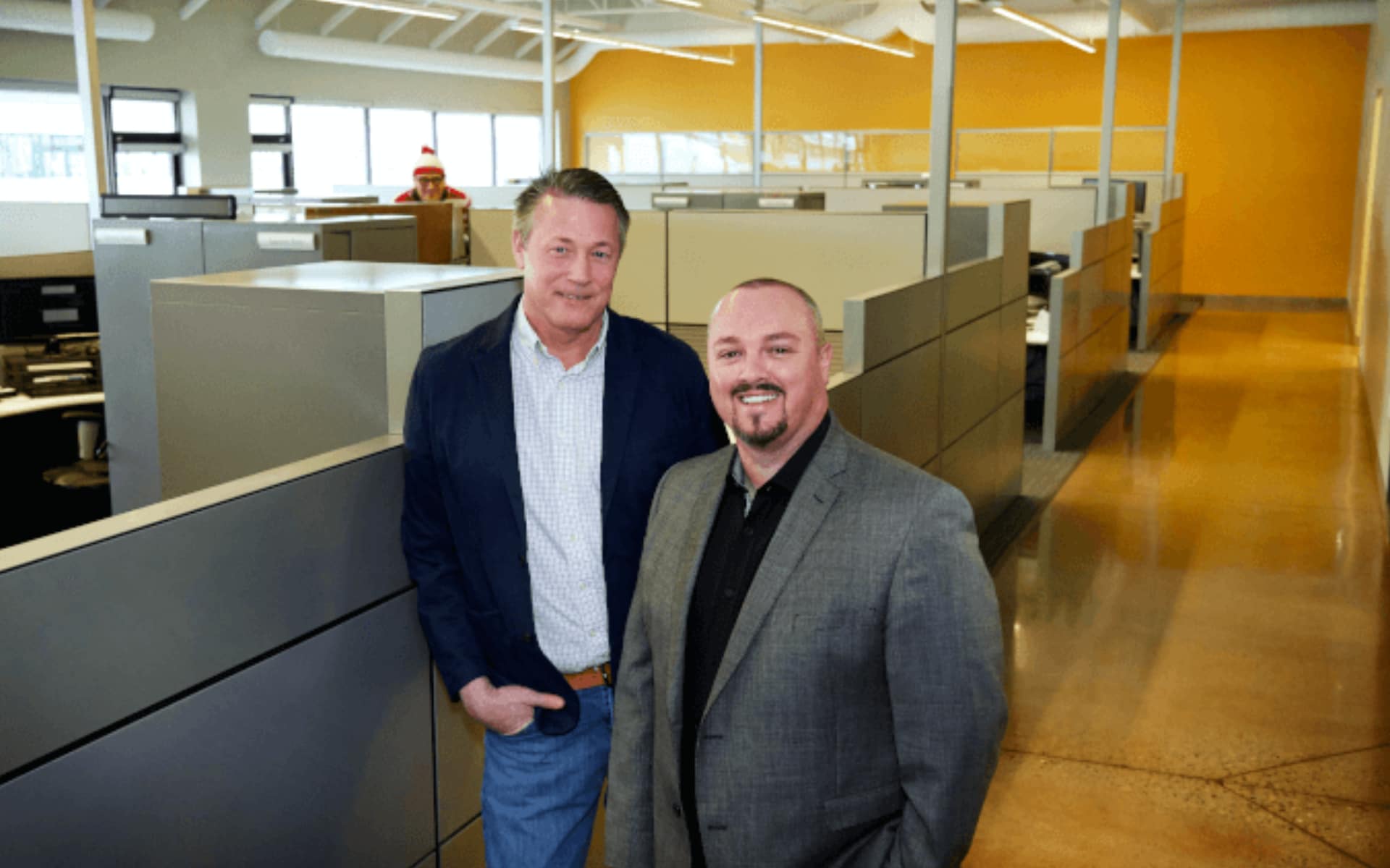 Arend van Eck and Brett Bickerton stand in the bullpen of MERAK Systems Woodlawn Road Office in Guelph, Ontario